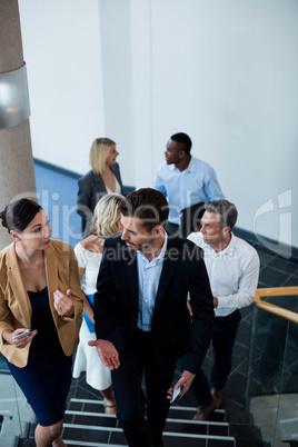 Business executives walking down the stairs