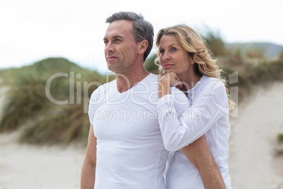 Mature couple standing together on the beach