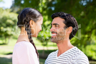 Father interacting with her daughter in park