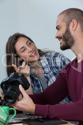 Photographers reviewing captured photos in his digital camera