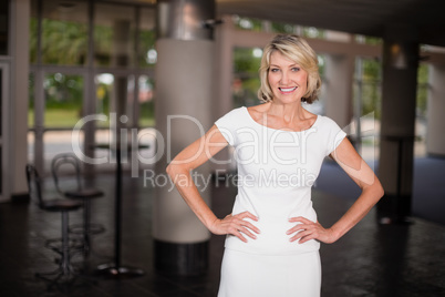 Happy businesswoman with arms crossed