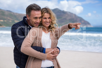 Mature couple embracing each other on the beach