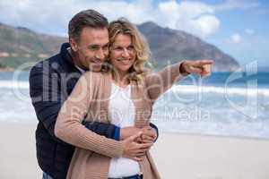 Mature couple embracing each other on the beach