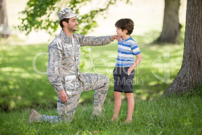 Army soldier interacting with boy