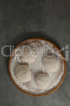 Pizza dough and flour on rolling board