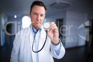 Portrait of male doctor holding stethoscope