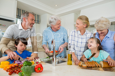 Happy family preparing food in kitchen