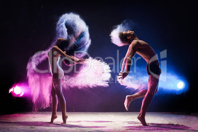 Sporty couple in color dust cloud studio shot