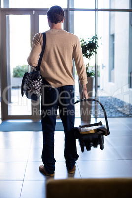 Man leaving the hospital with baby