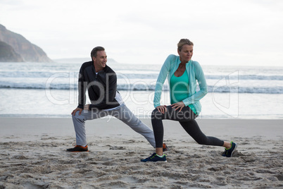 Mature couple doing stretching exercise