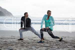 Mature couple doing stretching exercise