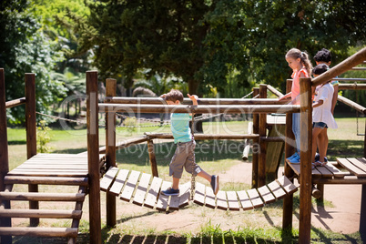 Kids playing on a playground ride in park
