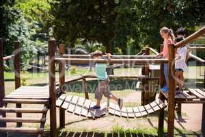 Kids playing on a playground ride in park