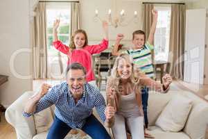 Portrait of parents and kids having fun in living room