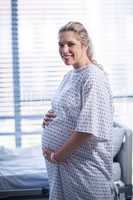 Portrait of pregnant woman standing in ward