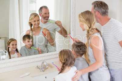 Parents and kids brushing teeth in bathroom