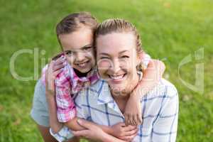 Mother holding hands of her daughter in park