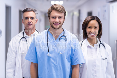 Portrait of smiling doctors standing in corridor