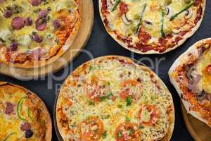 Various pizza arranged on a wooden tray