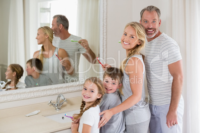 Parents and kids brushing teeth in bathroom