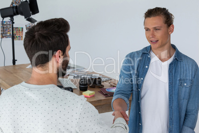 Photographers shaking hands