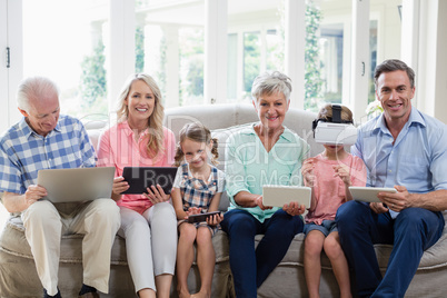 Multi-generation family using digital tablet, mobile phone and virtual headset in living room