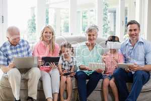 Multi-generation family using digital tablet, mobile phone and virtual headset in living room