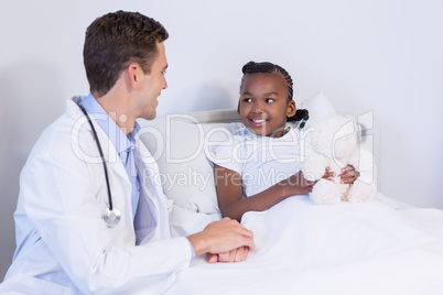 Doctor talking to a girl patient