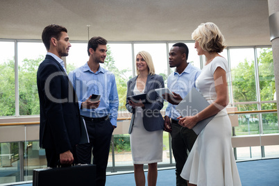 Business executives interacting in a conference center lobby