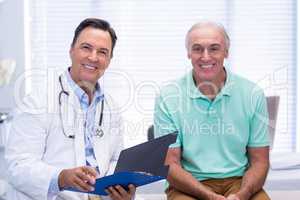 Portrait of smiling doctor and senior patient