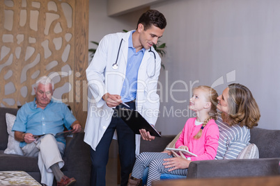 Doctor discussing a medical report with mother and daughter