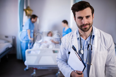 Portrait of male doctor holding a medical report