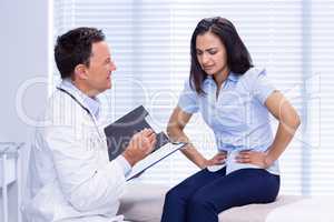 Patient suffering from stomach ache while consulting doctor