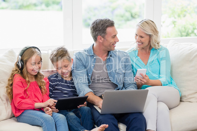 Parents and kids using digital tablet, mobile phones and laptop