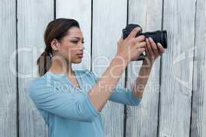 Female photographer reviewing captured photos in her digital camera