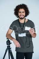 Portrait of male photographer showing identity card