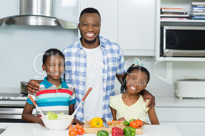 Father and Kids standing in kitchen at home