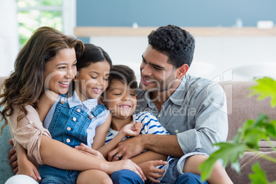 Parents and kids having fun in living room