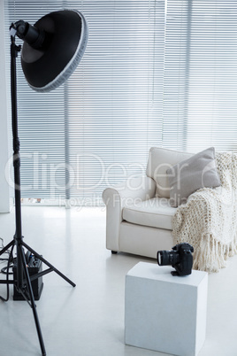 Armchair and spotlight in photostudio