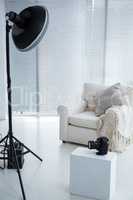 Armchair and spotlight in photostudio