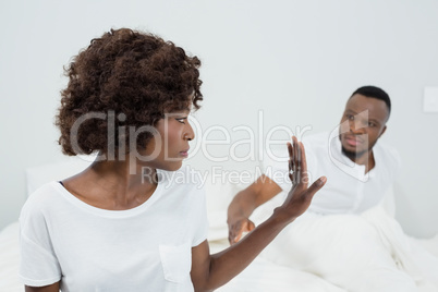 Couple arguing with each other in bedroom