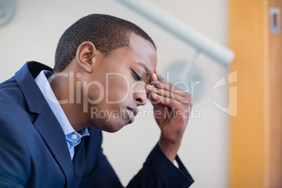 Worried businessman with hand on head