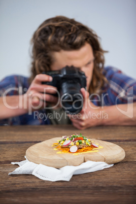 Male photographer photographing food