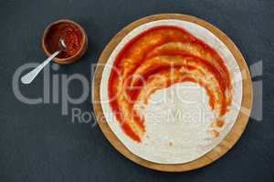 Pizza dough with tomato sauce