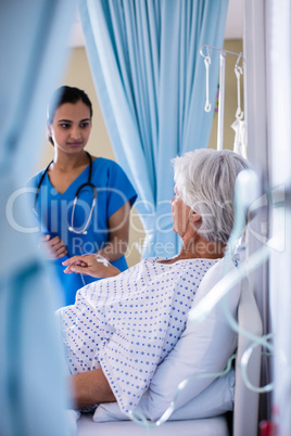 Female doctor examining senior woman