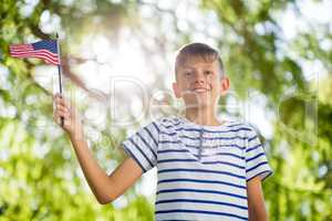 Boy holding small american flag