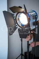 Photographer adjusting spotlight