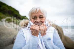 Portrait of senior woman standing on the beach