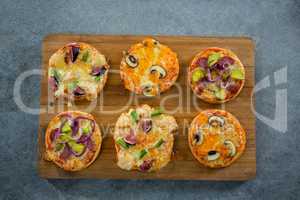 Various pizza arranged on a wooden tray