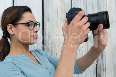 Female photographer reviewing captured photos in her digital camera